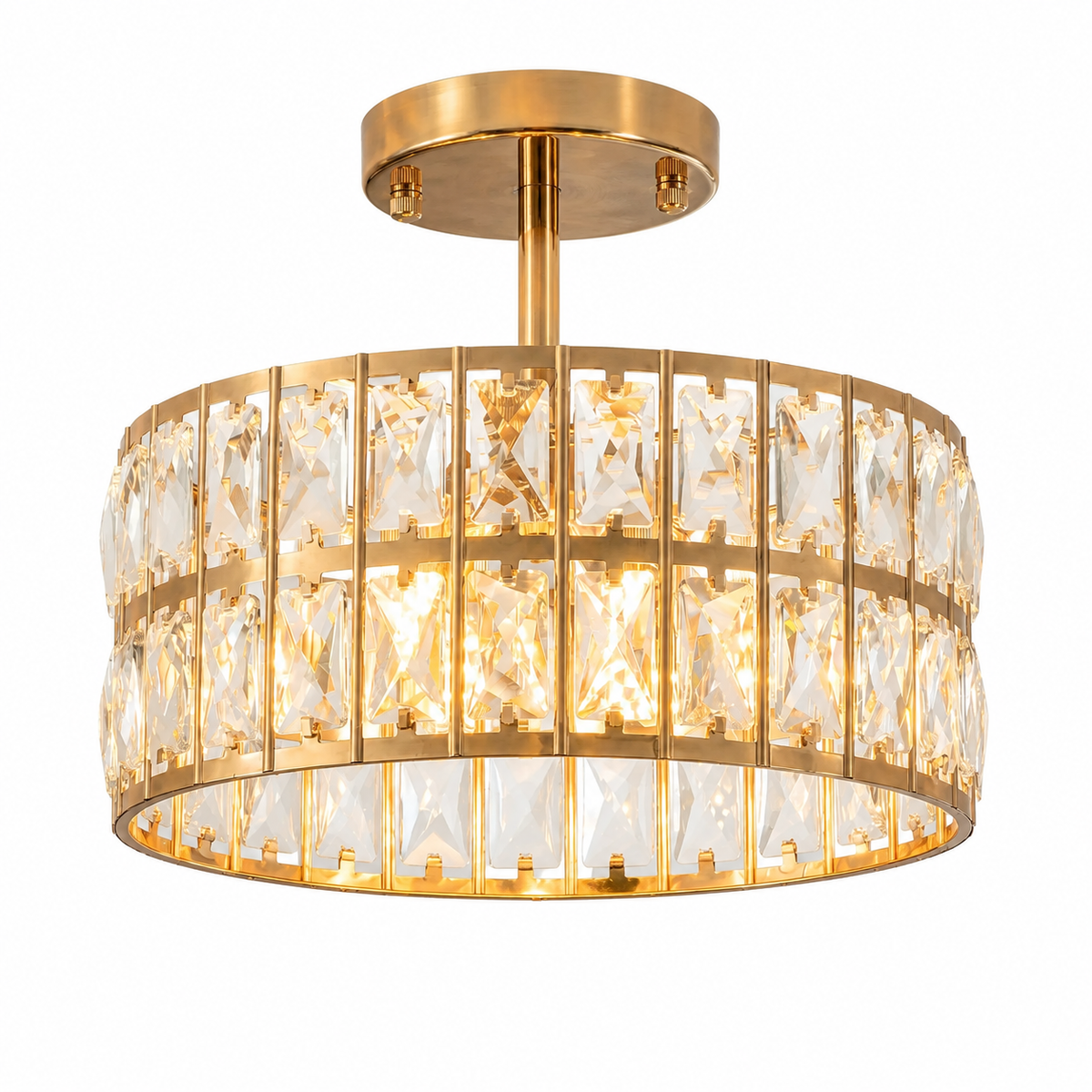 A modern semi-flush mount drum ceiling light featuring a brushed gold metal frame and clear faceted crystal prisms, shown illuminated against a solid white background.